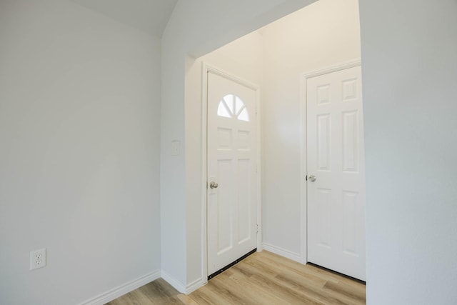 foyer featuring light wood-style flooring and baseboards