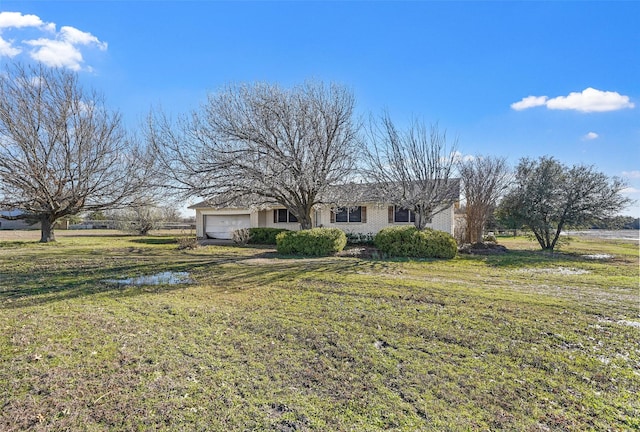 view of front of house with a front lawn and an attached garage