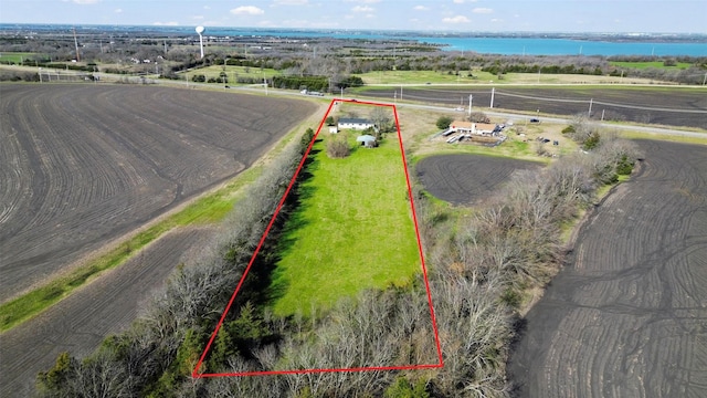 birds eye view of property with a rural view and a water view