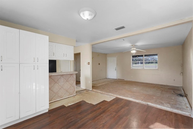 interior space with a ceiling fan and visible vents