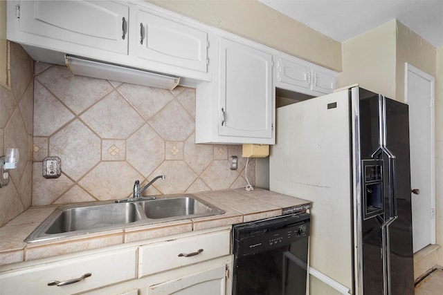 kitchen featuring fridge with ice dispenser, a sink, tasteful backsplash, black dishwasher, and white cabinets