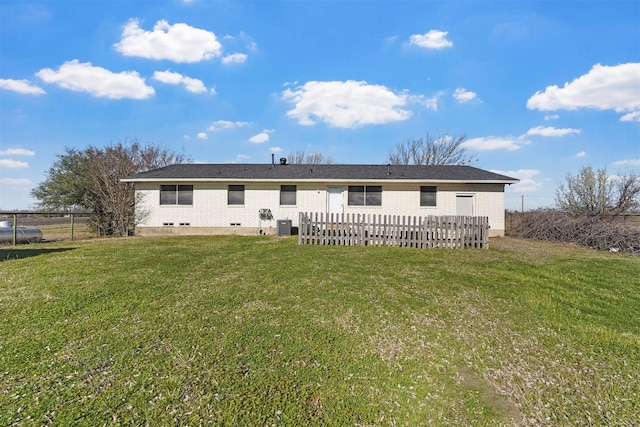 rear view of house with crawl space, cooling unit, a yard, and fence