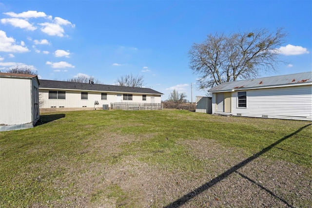 exterior space with an outdoor structure, a lawn, and crawl space