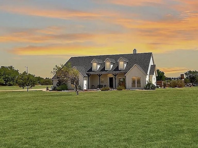 view of front of home with a front lawn and a chimney