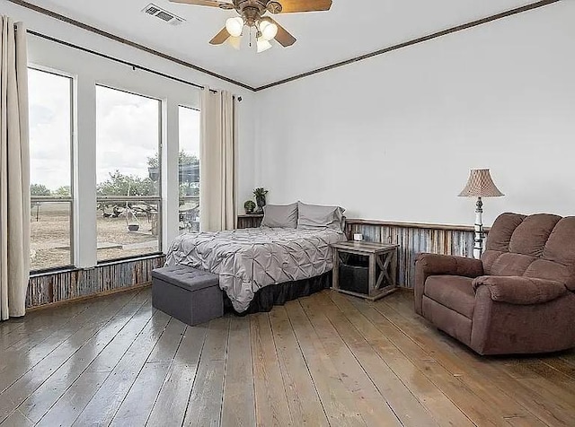 bedroom with a ceiling fan, visible vents, and wood-type flooring