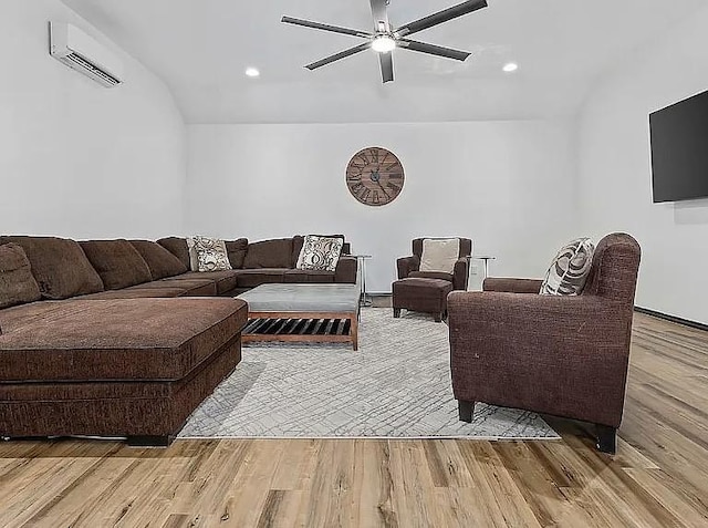 living area featuring an AC wall unit, light wood-style flooring, a ceiling fan, recessed lighting, and lofted ceiling