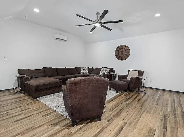 living room featuring light wood finished floors, an AC wall unit, lofted ceiling, recessed lighting, and a ceiling fan