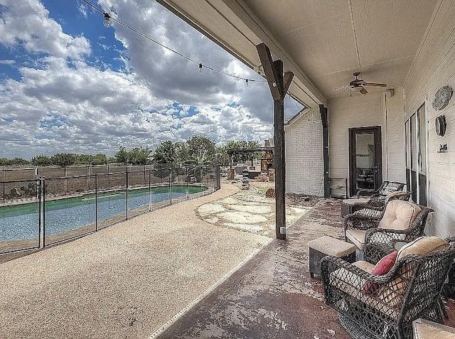 view of patio featuring a fenced in pool, a ceiling fan, and fence