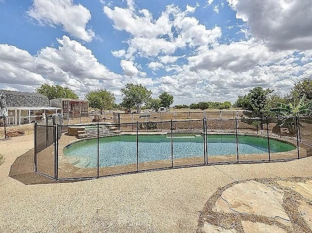 view of pool with a fenced in pool and fence