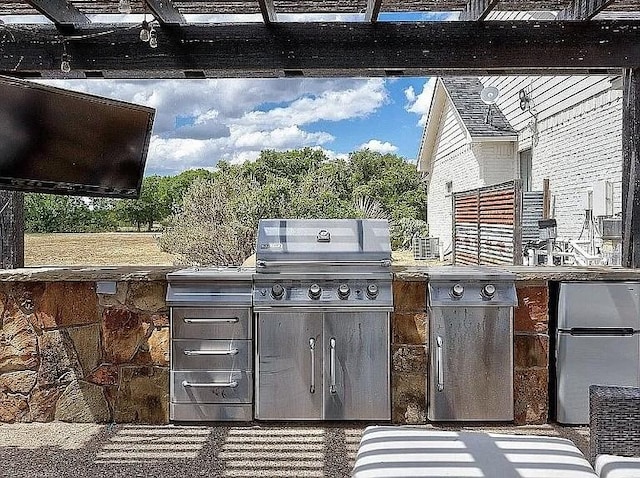 view of patio with a grill and an outdoor kitchen