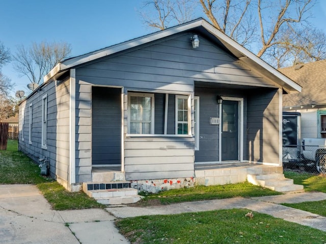 bungalow-style home featuring fence