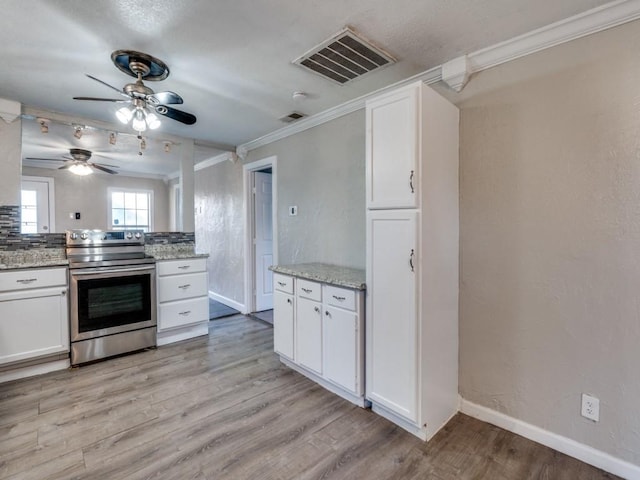 kitchen featuring white cabinets, stainless steel electric stove, light wood-style floors, and visible vents