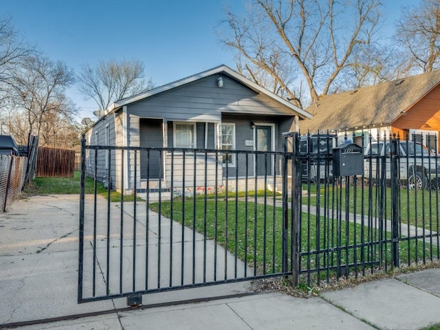 bungalow-style home featuring a fenced front yard and a front yard