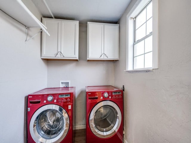 laundry room with washer and clothes dryer and cabinet space