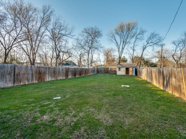 view of yard featuring an outbuilding and a fenced backyard