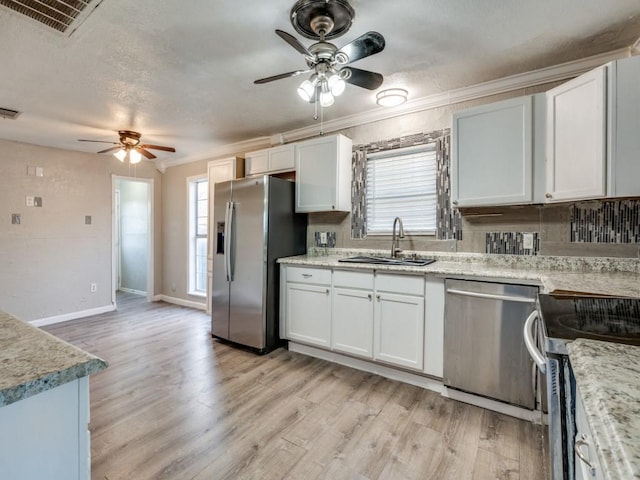 kitchen featuring a ceiling fan, visible vents, appliances with stainless steel finishes, and a sink