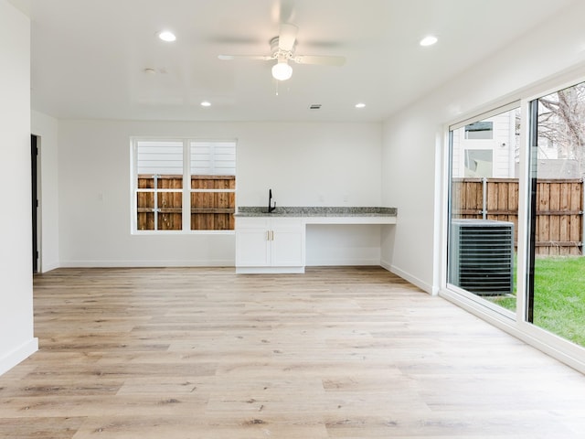 unfurnished living room with recessed lighting, baseboards, light wood-type flooring, and ceiling fan