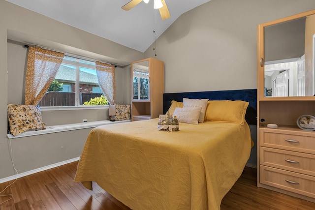 bedroom featuring lofted ceiling, wood finished floors, baseboards, and ceiling fan