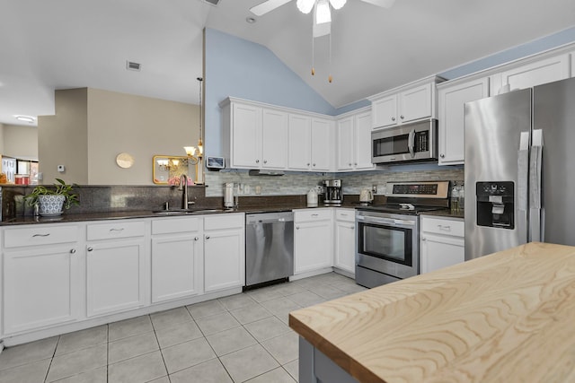 kitchen featuring visible vents, backsplash, light tile patterned flooring, stainless steel appliances, and a sink