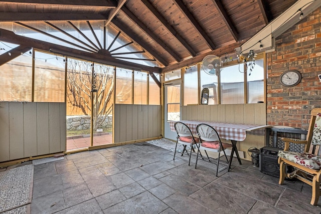 unfurnished sunroom featuring lofted ceiling with beams and wooden ceiling