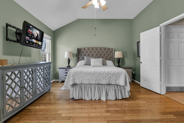 bedroom featuring baseboards, wood finished floors, a ceiling fan, and vaulted ceiling