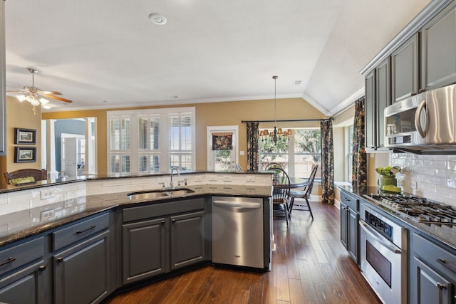 kitchen with ornamental molding, tasteful backsplash, appliances with stainless steel finishes, and a sink