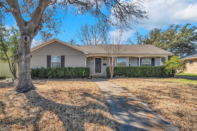 single story home featuring brick siding