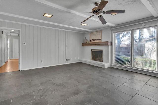 unfurnished living room featuring baseboards, a large fireplace, and ceiling fan