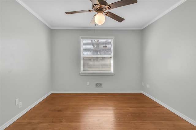 unfurnished room with baseboards, crown molding, ceiling fan, and wood finished floors