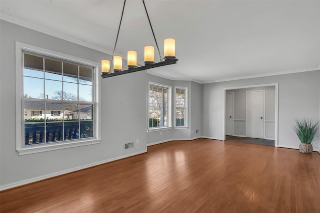 interior space with wood finished floors, baseboards, and ornamental molding