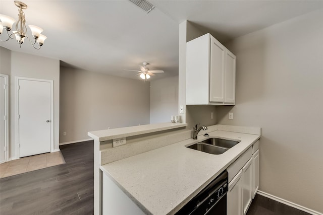 kitchen featuring dark wood-style floors, ceiling fan with notable chandelier, visible vents, and a sink