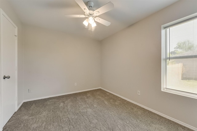 spare room featuring carpet flooring, baseboards, and ceiling fan