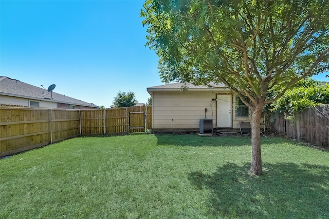 view of yard with central air condition unit and a fenced backyard