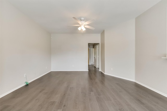 unfurnished room with baseboards, ceiling fan, and wood finished floors