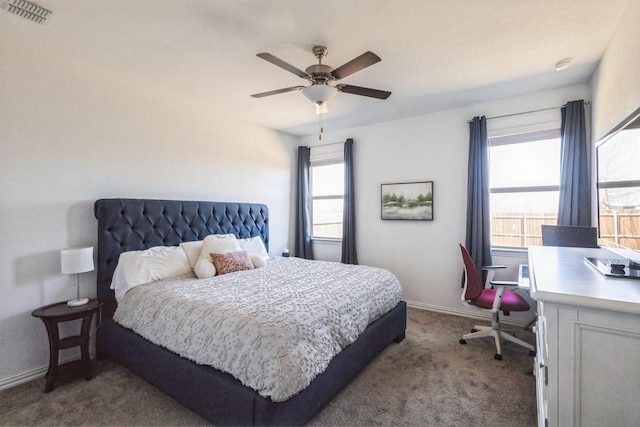 bedroom featuring visible vents, baseboards, ceiling fan, and dark carpet