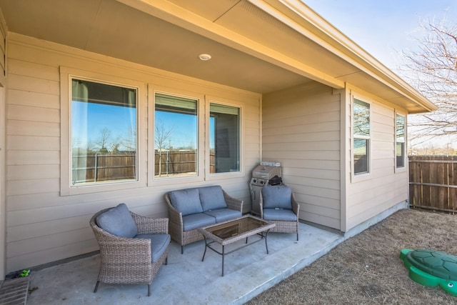 view of patio / terrace featuring a grill, fence, and an outdoor hangout area