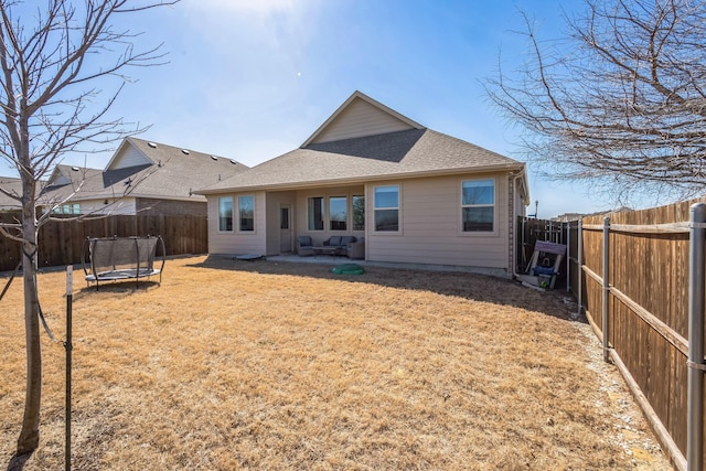 870 Sitwell Dr, Fate, TX 75087 - back of house featuring a trampoline, a shingled roof, and a patio area