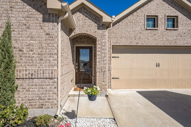 870 Sitwell Dr, Fate, TX 75087 - property entrance featuring concrete driveway, brick siding, and an attached garage
