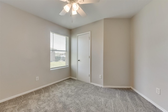 unfurnished room with carpet flooring, baseboards, and ceiling fan