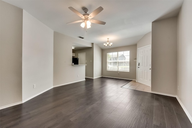 unfurnished living room with visible vents, ceiling fan with notable chandelier, dark wood-type flooring, and baseboards