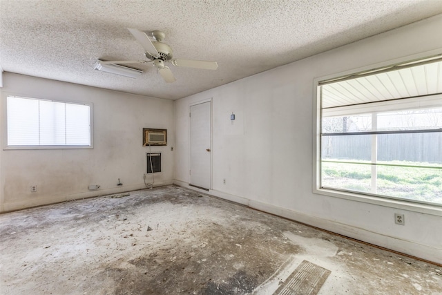 unfurnished room featuring baseboards, a textured ceiling, and a ceiling fan