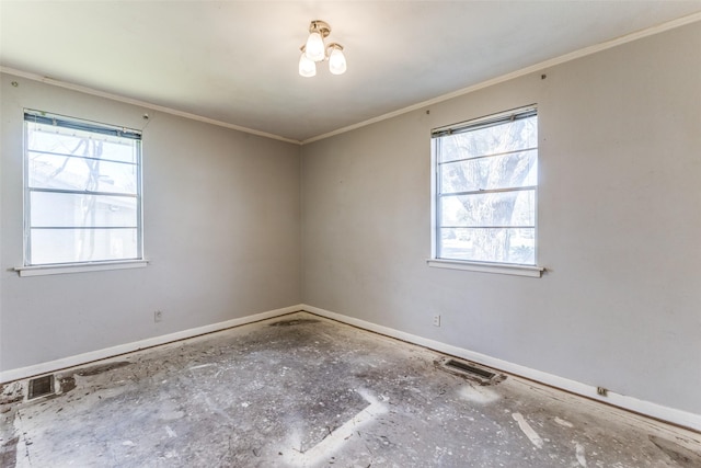 unfurnished room featuring crown molding, visible vents, and baseboards