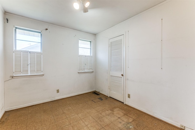 unfurnished room featuring tile patterned floors and baseboards