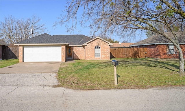 ranch-style house featuring driveway, fence, a front yard, a garage, and brick siding