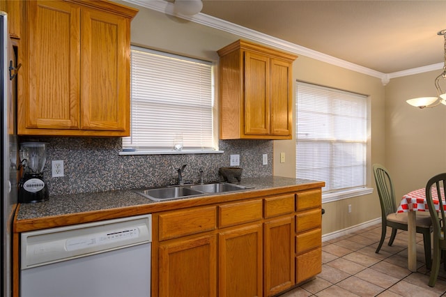 kitchen with a sink, backsplash, white dishwasher, crown molding, and tile counters