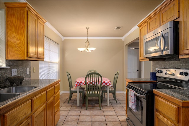 kitchen with visible vents, a notable chandelier, ornamental molding, dark countertops, and appliances with stainless steel finishes