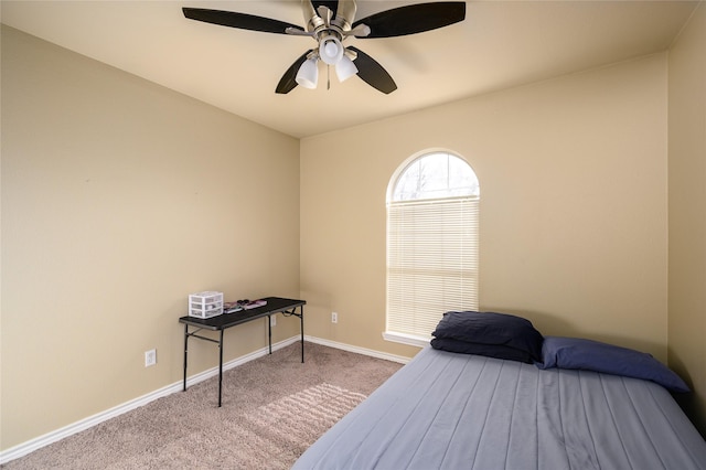 carpeted bedroom featuring a ceiling fan and baseboards