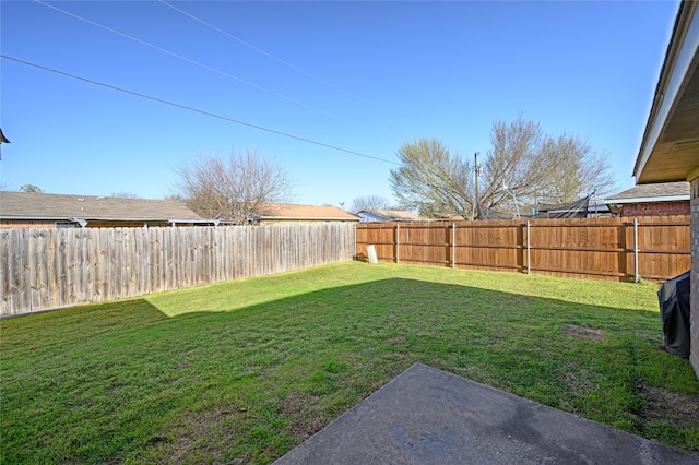 view of yard with a fenced backyard