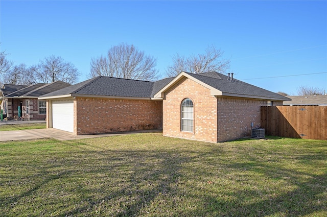 view of property exterior featuring fence, concrete driveway, a garage, a lawn, and brick siding