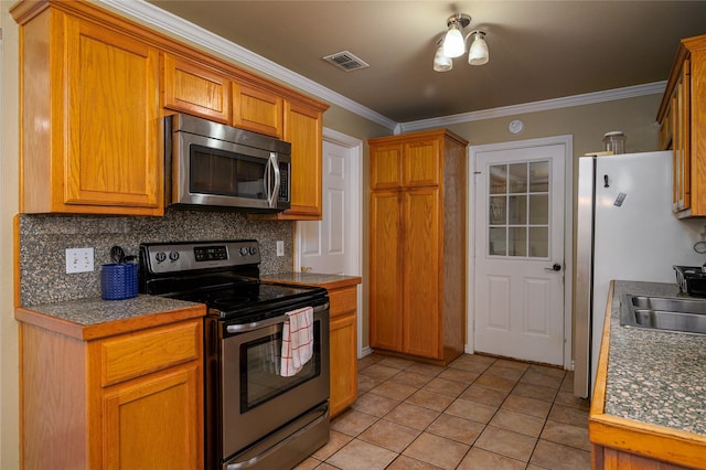 kitchen featuring visible vents, ornamental molding, light tile patterned floors, decorative backsplash, and stainless steel appliances